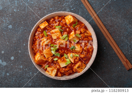 Mapo tofu garnished with green onions in bowl top view, traditional Chinese dish 118280913