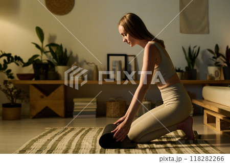 Unrolling mat before fitness training Unrolling mat before fitness training 118282266
