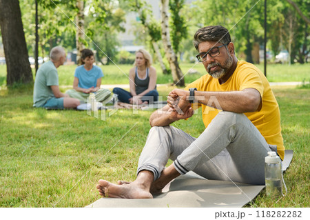 Mature active man looking at smartwatch 118282282