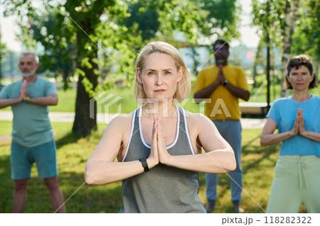 Woman with hands put together by chest Woman with hands put together by chest 118282322