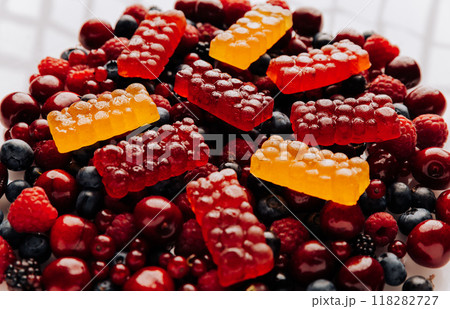 Colorful natural berry marmalade on fresh mixed fruits and berries, healthy sweet indulgence 118282727