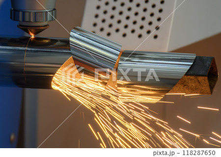 Close up scene the fiber laser cutting machine cut the stainless steel tube and sparkling light. 118287650