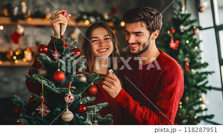Young couple decorating Christmas tree together 118287951
