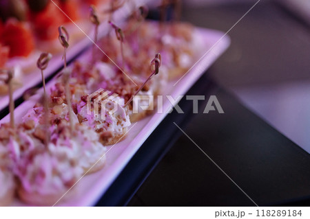 A plate of food with a pink background and a white plate A plate of food with a pink background and a white plate 118289184