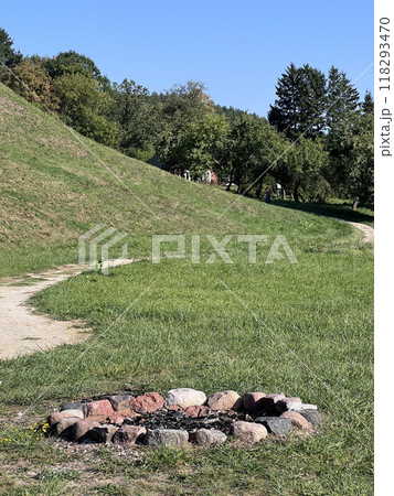 A small fire pit in a forest. It has not been used in a long time as there is no charred wood in it, it has all weathered away. A small fire pit in a forest. It has not been used in a long time as there is no charred wood in it, it has all weathered away. 118293470