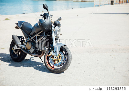 Black sports motorcycle parked in the parking lot 118293856