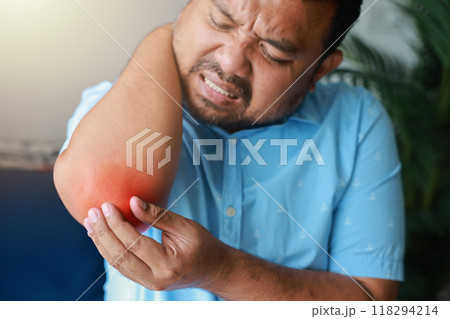 A man injured his elbow and it was swollen and red. Causes of pain include Lifting heavy objects, Gout, Rheumatoid arthritis, office syndrome, numbness, and cramp symptoms. Healthcare medical concept. 118294214