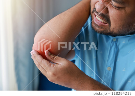 A man injured his elbow and it was swollen and red. Causes of pain include Lifting heavy objects, Gout, Rheumatoid arthritis, office syndrome, numbness, and cramp symptoms. Healthcare medical concept. 118294215