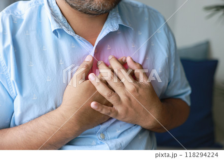 A man injured his left breast. Causes of pain include Heart disease, Pleurisy, Costochondritis, Pectoral muscle inflammation, and Acid reflux disease. Healthcare medical concept. A man injured his left breast. Causes of pain include Heart disease, Pleurisy, Costochondritis, Pectoral muscle inflammation, and Acid reflux disease. Healthcare medical concept. 118294224