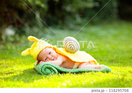 Baby in cute dress up costume. Newborn in garden. 118295708