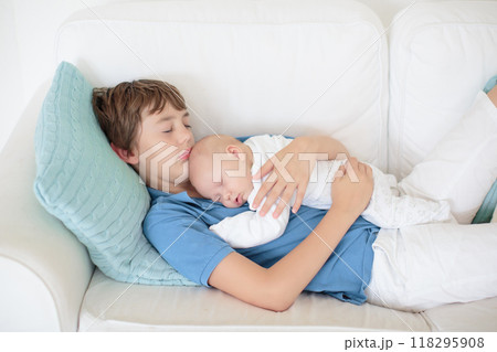 Child watching newborn baby in bassinet. Child watching newborn baby in bassinet. 118295908