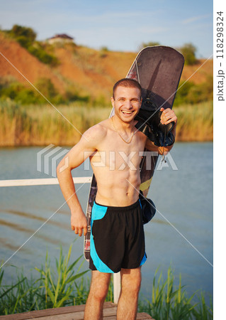 A young man learns to wakeboard.  118298324