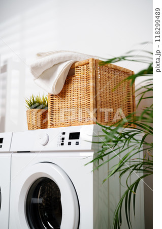 White Towels In Wicker Basket On Top Of White Washing Machine 118299489