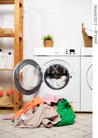 Laundry Day in a Modern Home With White Washers and a Wooden Shelf 118299490