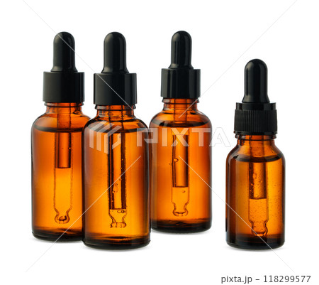 Amber Glass Dropper Bottles With Liquid Against a White Background 118299577