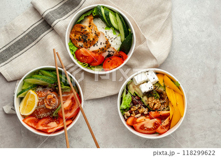 Beautiful composition with poke bowls on gray background with napkin Beautiful composition with poke bowls on gray background with napkin 118299622
