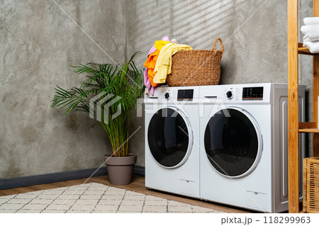 Modern White Washing Machines in Laundry Room With Open Door Modern White Washing Machines in Laundry Room With Open Door 118299963
