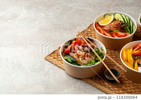 Fresh poke bowl on straw mat close up Fresh poke bowl on straw mat close up 118300064