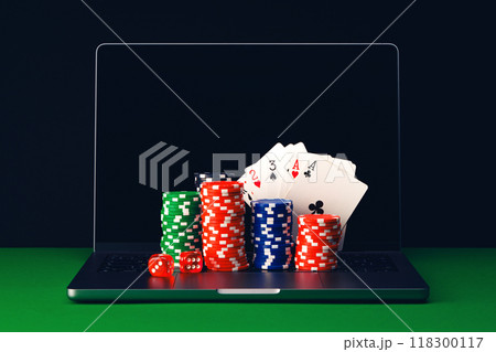 Stacks of Poker Chips and Playing Cards on a Laptop Computer. Stacks of Poker Chips and Playing Cards on a Laptop Computer. 118300117