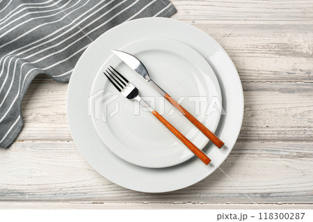 Empty plate with fork and knife on table Empty plate with fork and knife on table 118300287