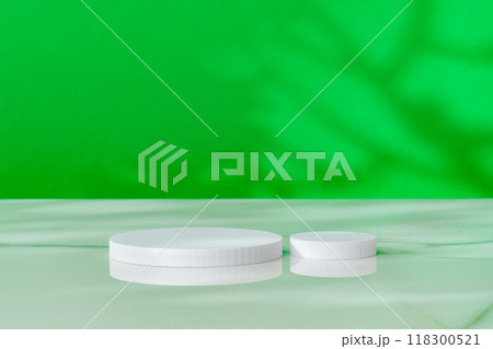 Decorative podiums on green background in studio 118300521