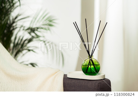 Aroma diffuser bottle with sticks in living room 118300824