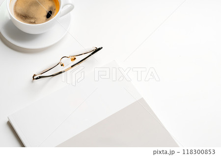 Blank paper, coffee cup and glasses on white desk Blank paper, coffee cup and glasses on white desk 118300853
