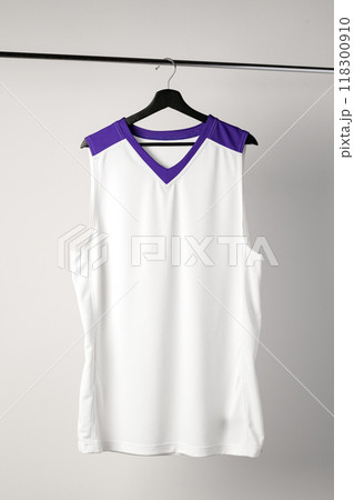 White basketball jersey hanging against white background 118300910