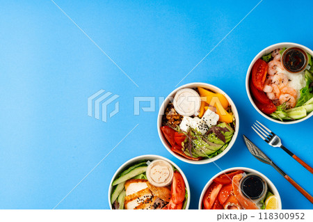 Different poke bowls on blue background top view Different poke bowls on blue background top view 118300952