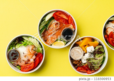Top view of fresh poke bowls on yellow background Top view of fresh poke bowls on yellow background 118300953
