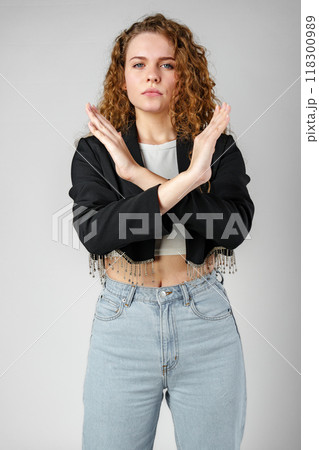 Young Woman Standing With Her Arms Crossed Young Woman Standing With Her Arms Crossed 118300989
