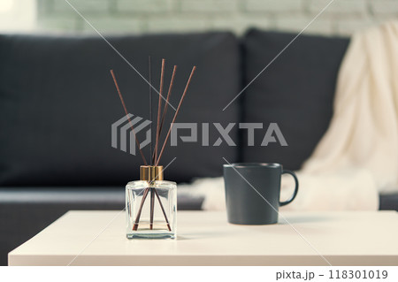 Aroma diffuser bottle with sticks in living room 118301019