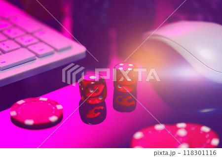 Red Dice on a Pink Surface With a Computer Keyboard and Mouse 118301116