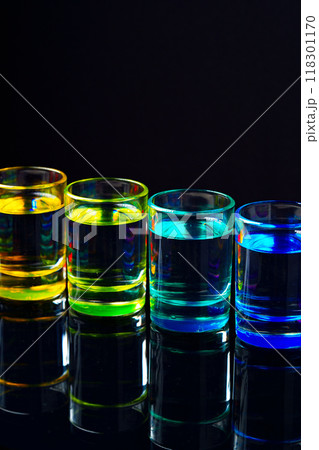 Colorful small glasses on black background with alcohol drink 118301170