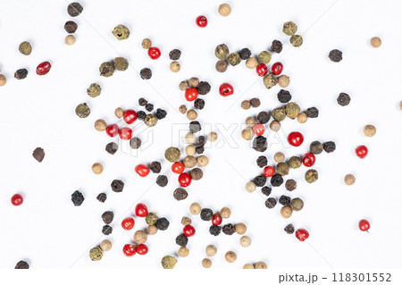 Red, green, white and black peppercorns on a white background top view. Red, green, white and black peppercorns on a white background top view. 118301552