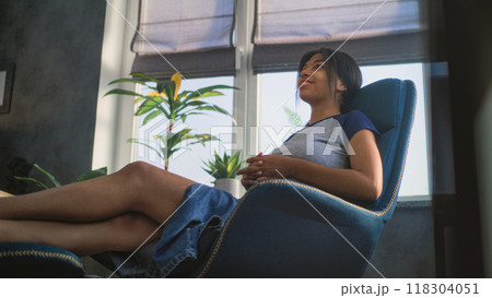 African American teenage girl sits in chair, talks during counseling session 118304051
