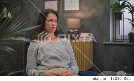 Stressed woman discusses psychological trauma during therapy with psychotherapist Stressed woman discusses psychological trauma during therapy with psychotherapist 118304066