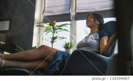 African American teenage girl sits in chair, talks during counseling session African American teenage girl sits in chair, talks during counseling session 118304067
