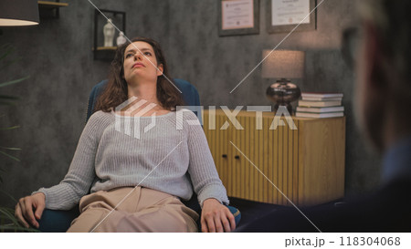 Depressed female patient on counseling session with psychologist 118304068