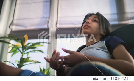 Close up of African American teenage girl sitting and talking with psychologist Close up of African American teenage girl sitting and talking with psychologist 118304219