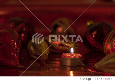 Christmas still life with red baubles and candle Christmas still life with red baubles and candle 118304961