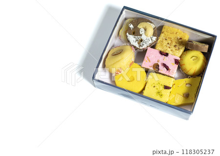 Indian mixed sweets in box on white background with copy space. Top view Indian mixed sweets in box on white background with copy space. Top view 118305237