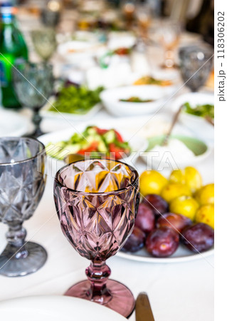 empty faceted wine glass on served table empty faceted wine glass on served table 118306202