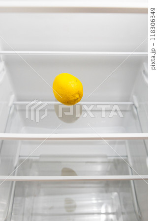 refrigerator with single lemon on glass shelf refrigerator with single lemon on glass shelf 118306349