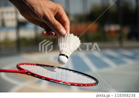 White badminton shuttlecock and badminton rackets on floor sport badminton court in sunny shadow. Outdoors. Close up. 118308238