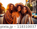 Three joyful women sharing a connected moment, radiant smiles 118310037