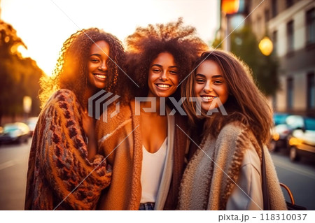 Three joyful women sharing a connected moment, radiant smiles 118310037