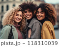 Three joyful women sharing a connected moment, radiant smiles 118310039