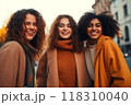 Three joyful women sharing a connected moment, radiant smiles 118310040