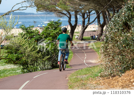 Person riding a bicycle on a cycle path 118310376